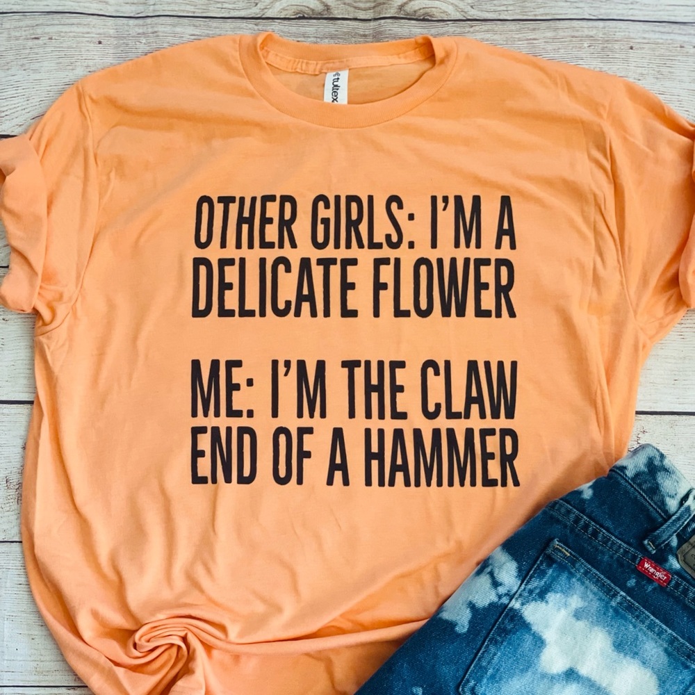 Other girls: I’m a delicate flower graphic tee